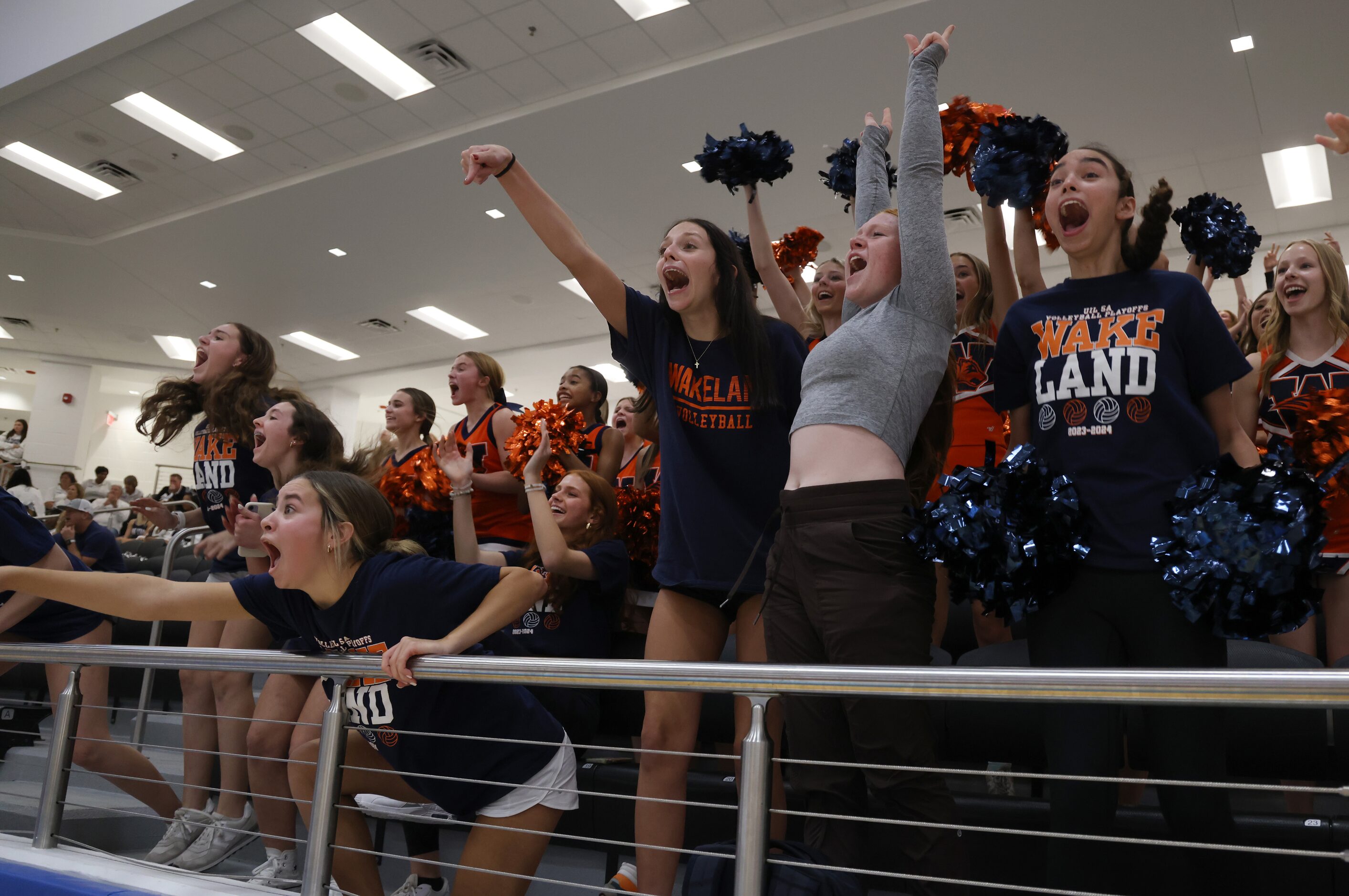 Members of the Frisco Wakeland junior varsity volleyball team show their support for varsity...