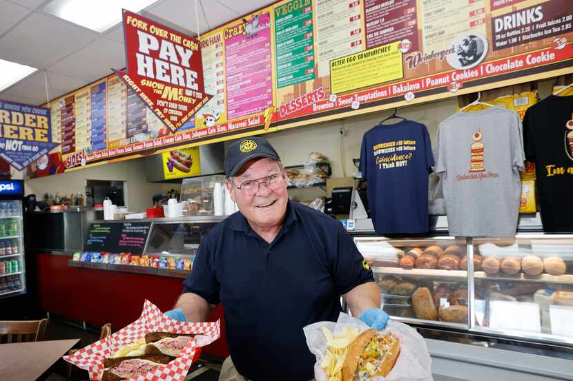 Weinberger's Deli Owner Dan Weinberger poses for a photo holding a Reuben sandwich and an...