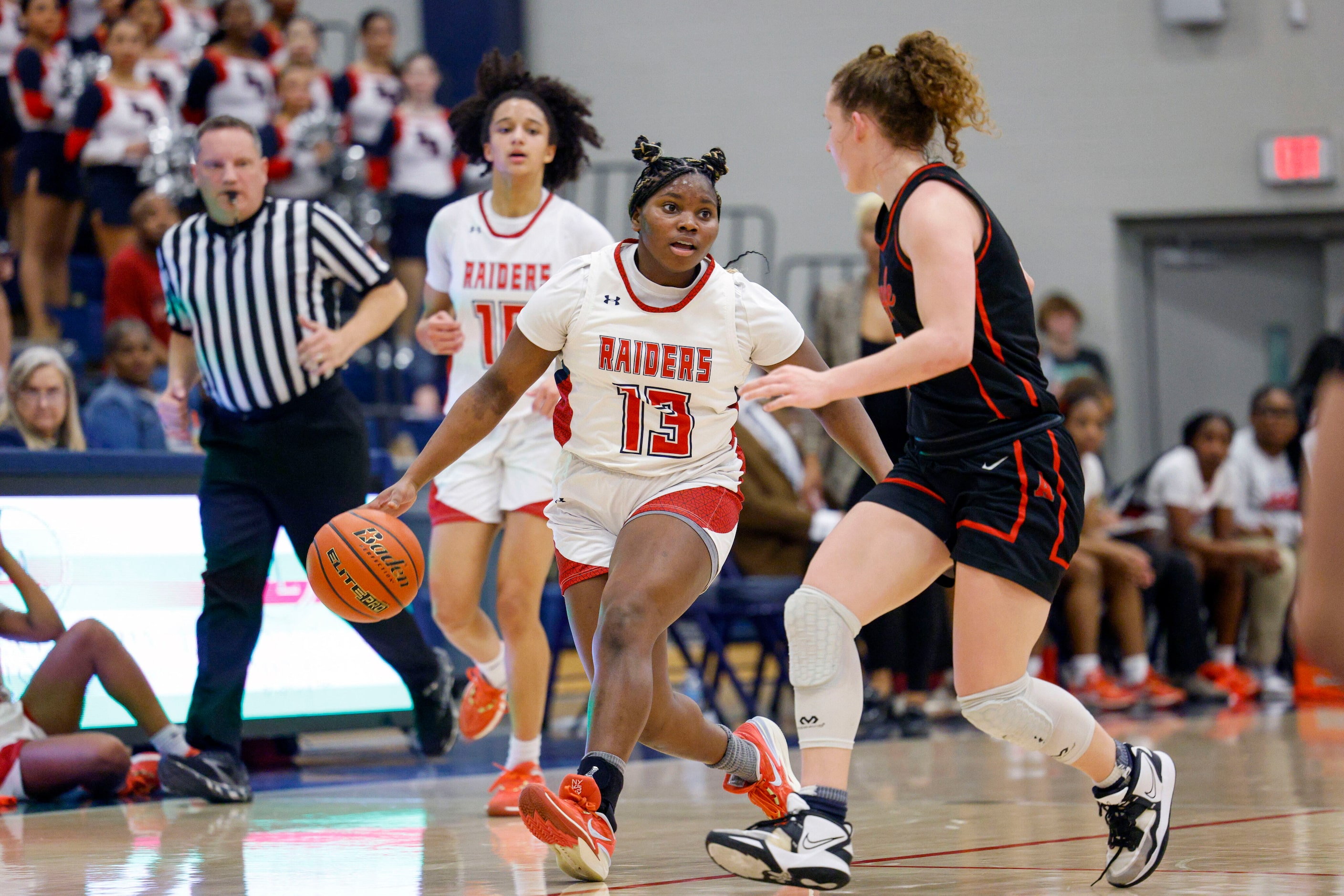 Denton Ryan forward Jamayla Anderson (13) dribbles up court alongside Argyle guard Wrigley...