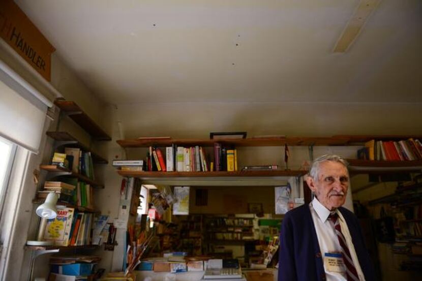 
Robert Jones stands among books of various languages in his shop, Imported Books, in Oak...