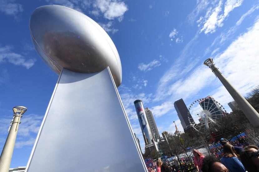 Fans gather at the Centennial Olympic Park during the  Super Bowl Experience outside the...
