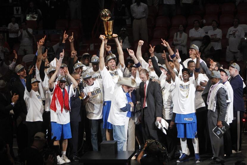 Dallas Mavericks team celebrate as the team is presented the Larry O'Brien NBA Championship...