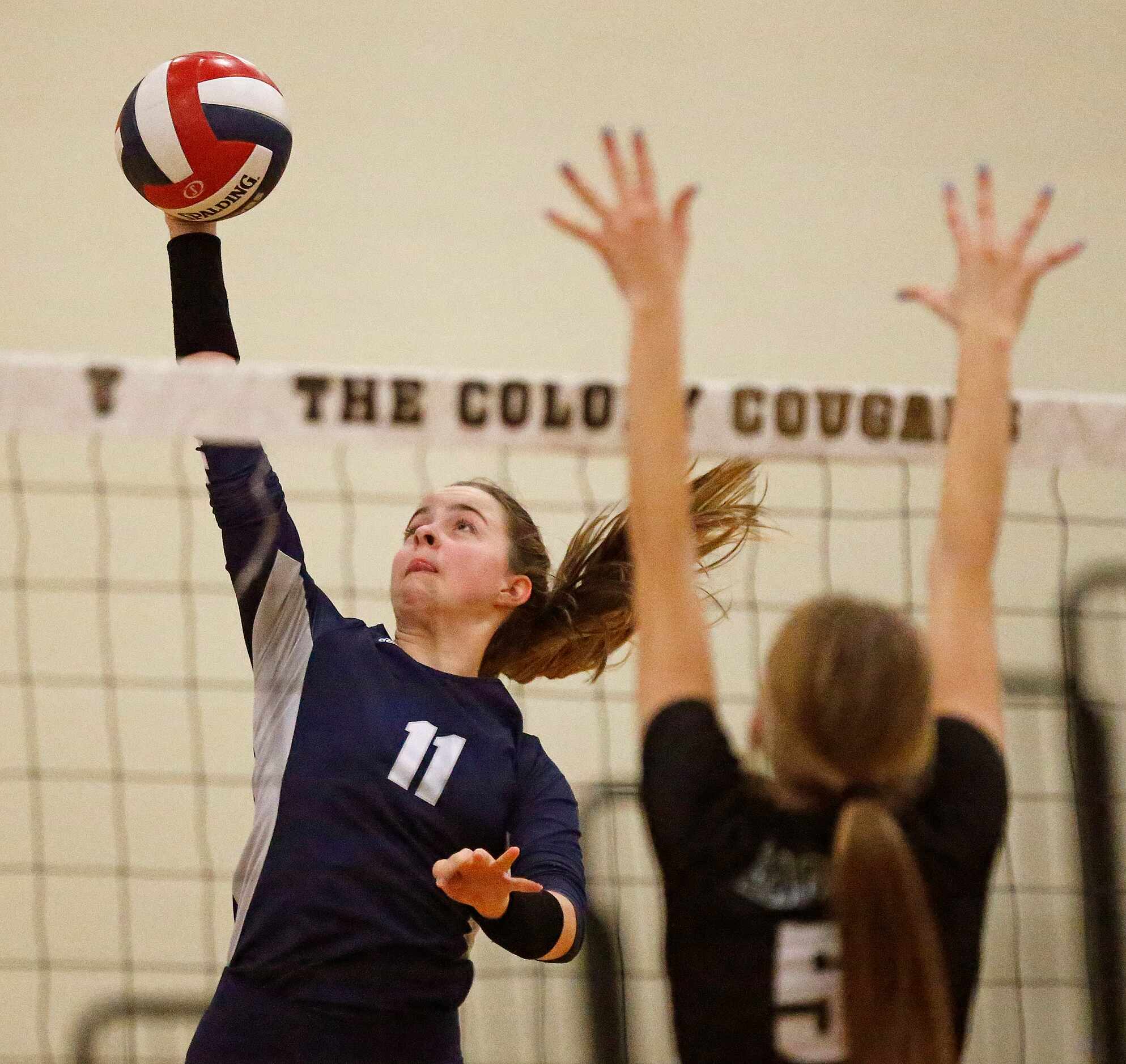 Flower Mound High School outside hitter Cat Young (11) gets a ht during game two of the...