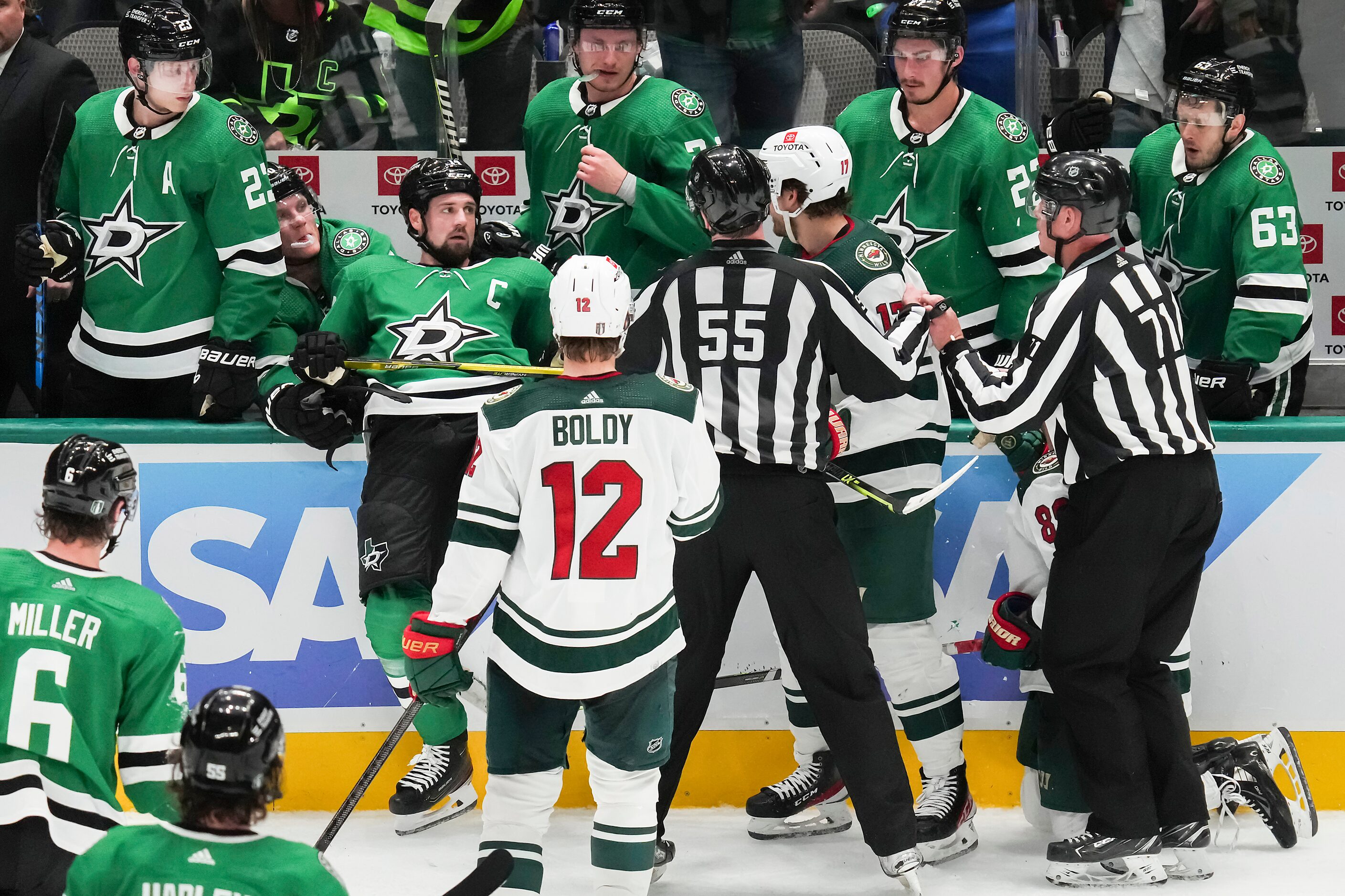 Officials try to separate Dallas Stars left wing Jamie Benn (left) from Minnesota Wild left...