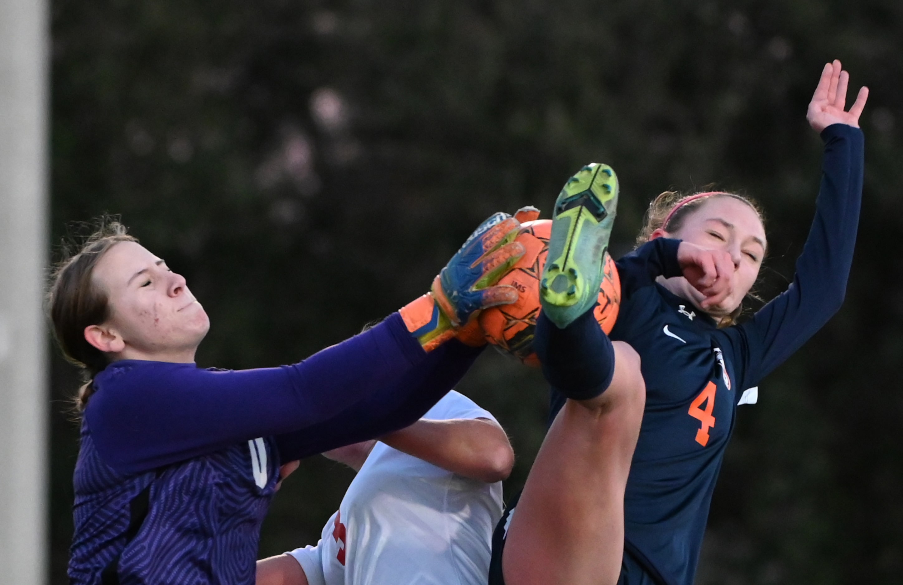 Frisco Centennial goalkeeper Caroline Hugely and Frisco Wakeland Lauren Vacek (4) go after a...