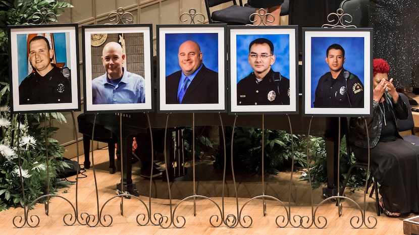 Photos of five officers who died were displayed during during an interfaith memorial service...