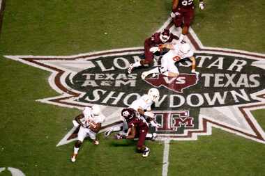 Texas Longhorns wide receiver Marquise Goodwin (84) is tackled by Texas A&M Aggies defensive...