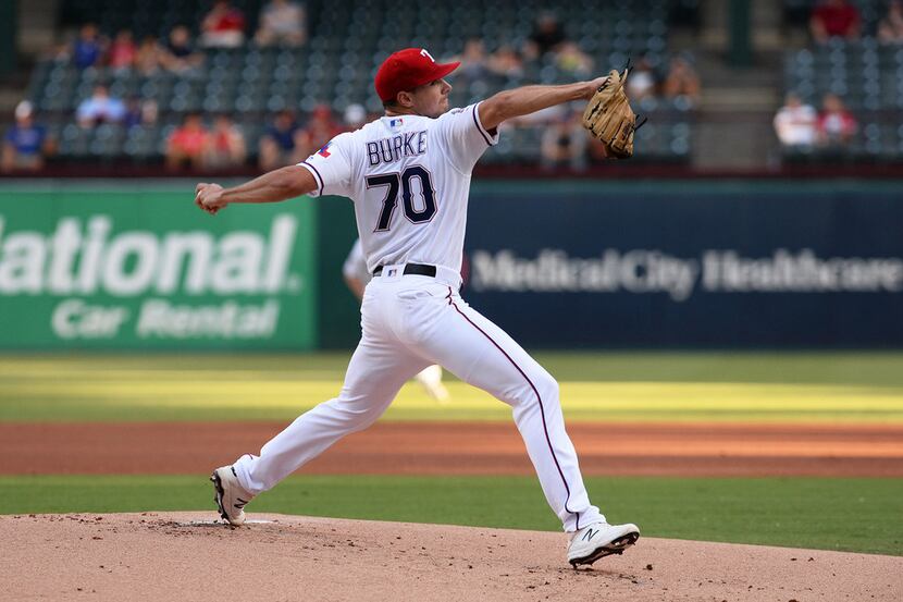 Brock Burke of the Texas Rangers pitches against the Los Angeles Angels in the first inning...