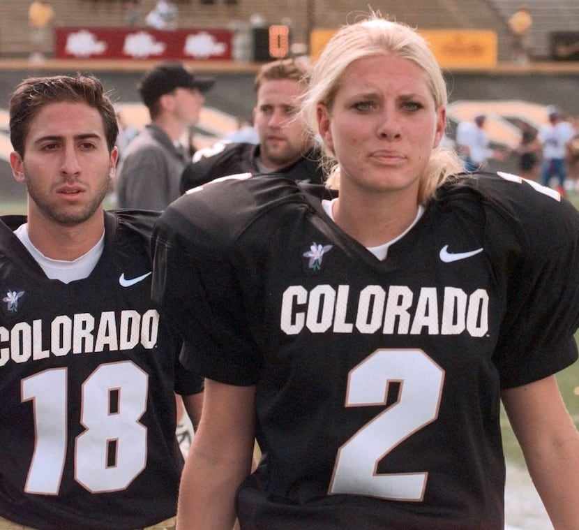 Colorado backup place kickers Katie Hnida (2) and Matt Altman head to the sidelines after...