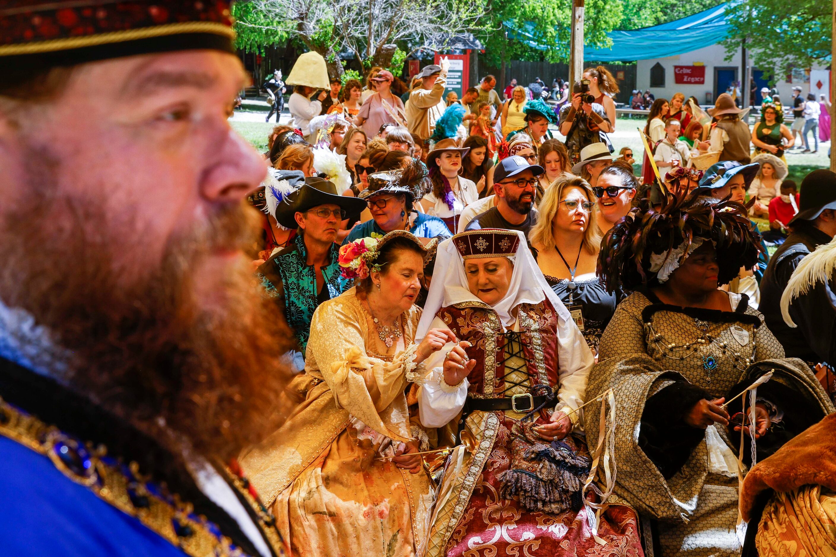 Cast members and crowd wait before the act of the Royal Wedding of King Henry VIII and Queen...