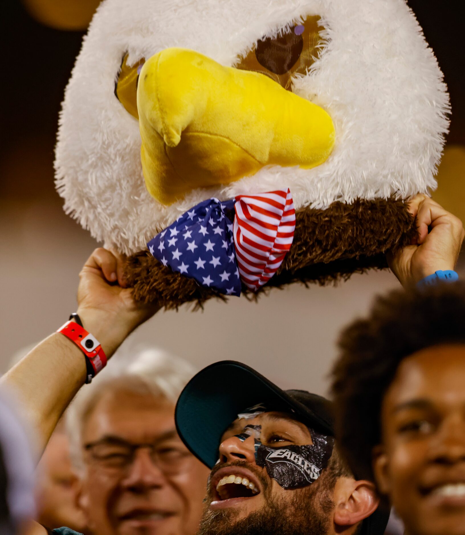 A Philadelphia Eagles fan lifts an eagle head during the first half of a Dallas Cowboys at...