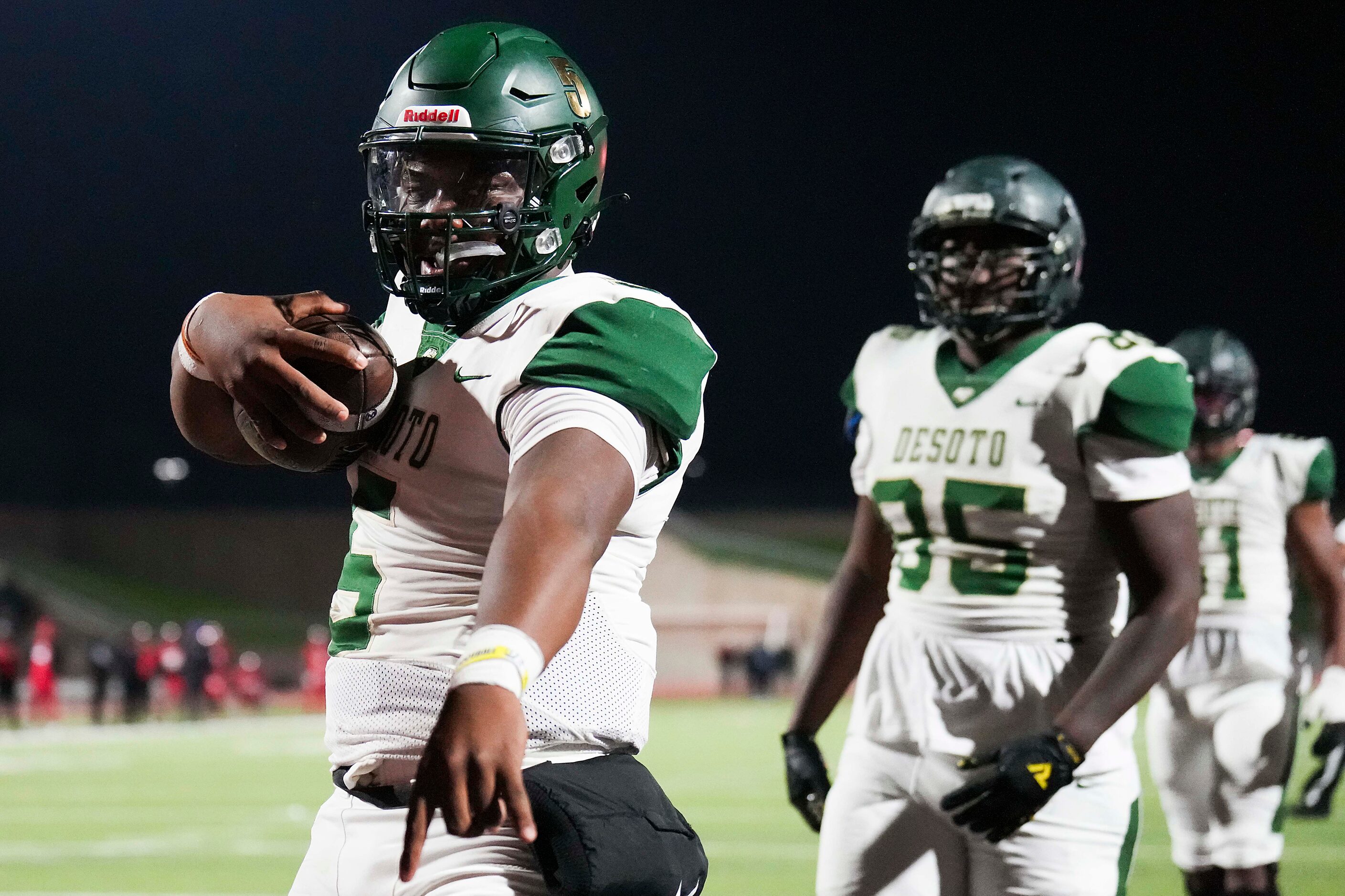 DeSoto quarterback Darius Bailey (5) celebrates after scoring for a 2-point conversion...