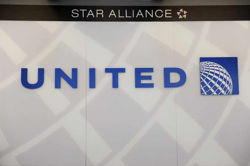 (FILES) This file photo taken on August 13, 2013 shows a United Airlines logobehind the...