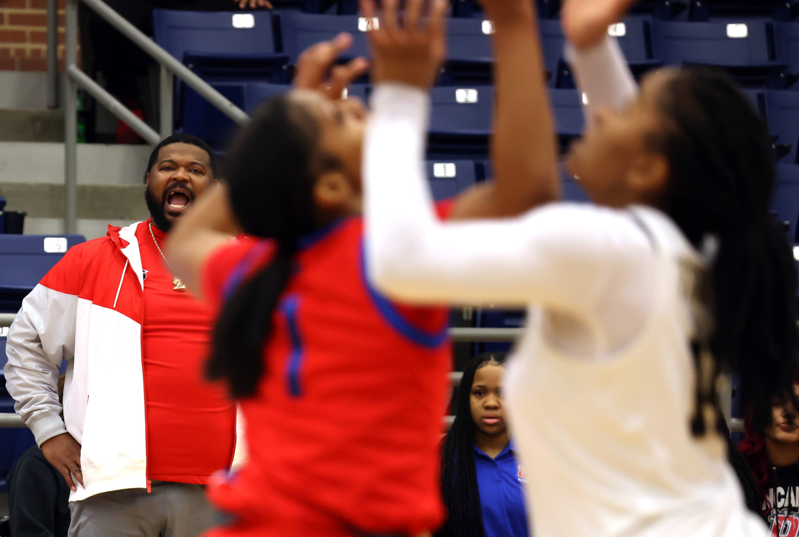 Duncanville head coach Neiman Ford, left, encourages his players from the team bench area...