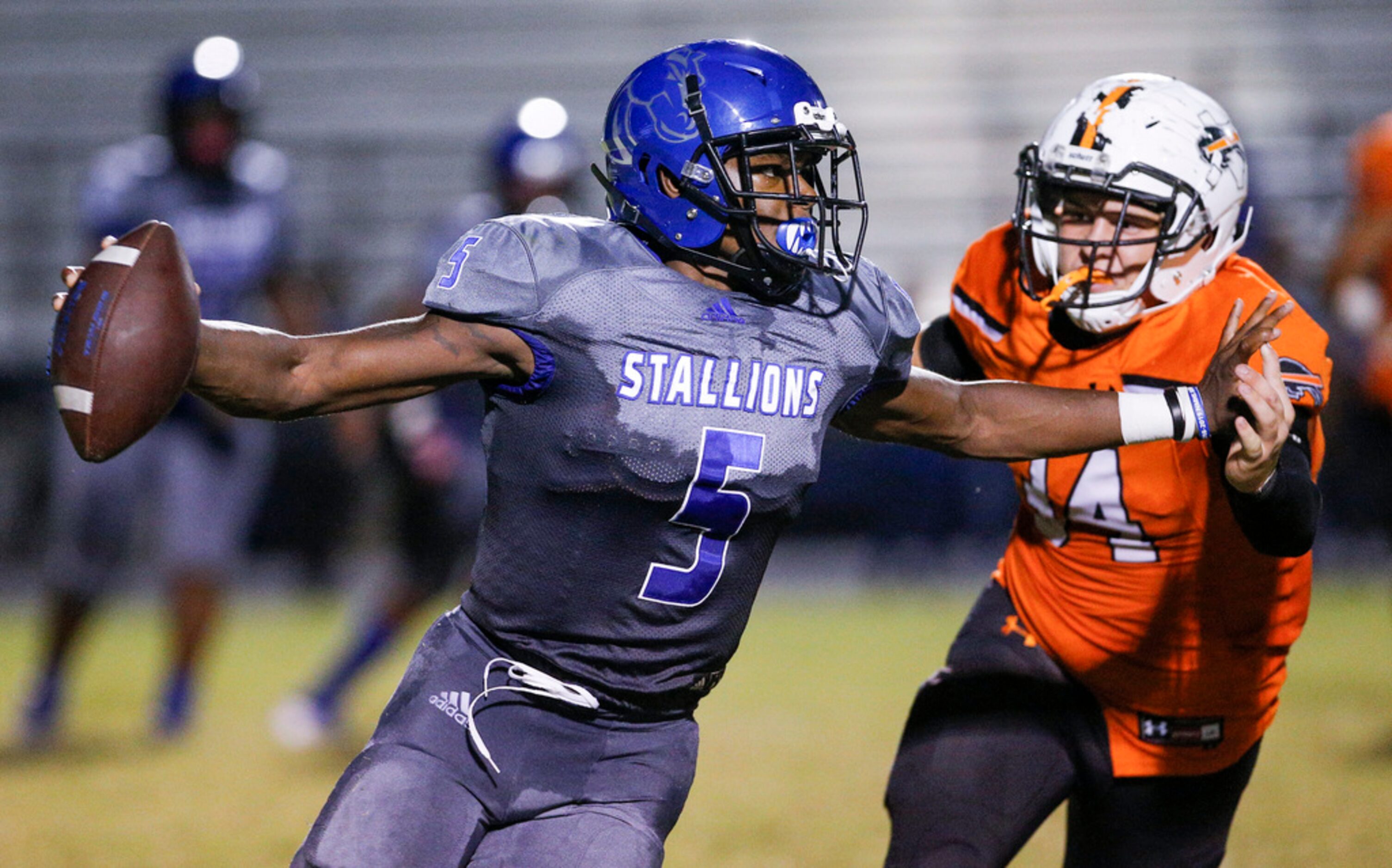 TXHSFB North Mesquite senior quarterback Kamaury Thompson (5) looks for room against Haltom...