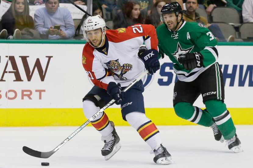 Florida Panthers center Vincent Trocheck (21) skates with the puck past Dallas Stars center...