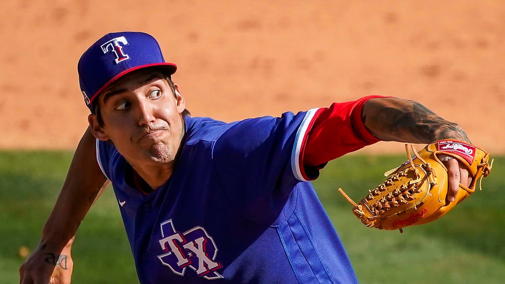 Texas Rangers pitcher Hans Crouse delivers during the fifth inning of a spring training game...
