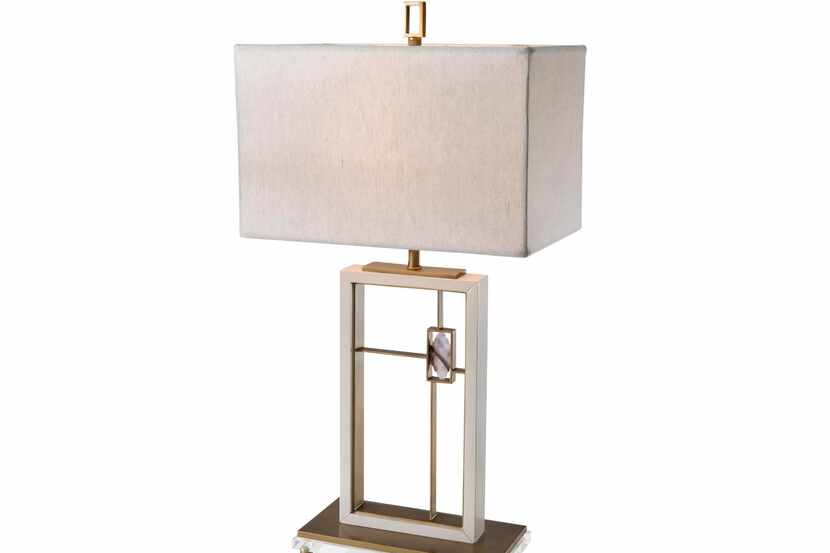 
The open, rectangular base of this contemporary lamp has brass crossbars that frame an...