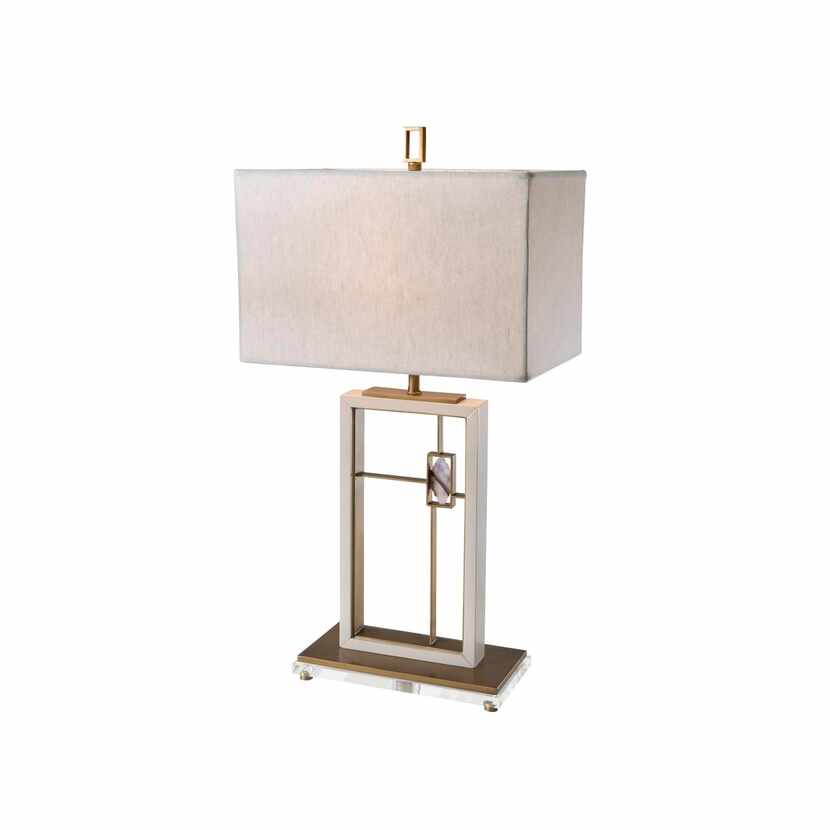 
The open, rectangular base of this contemporary lamp has brass crossbars that frame an...