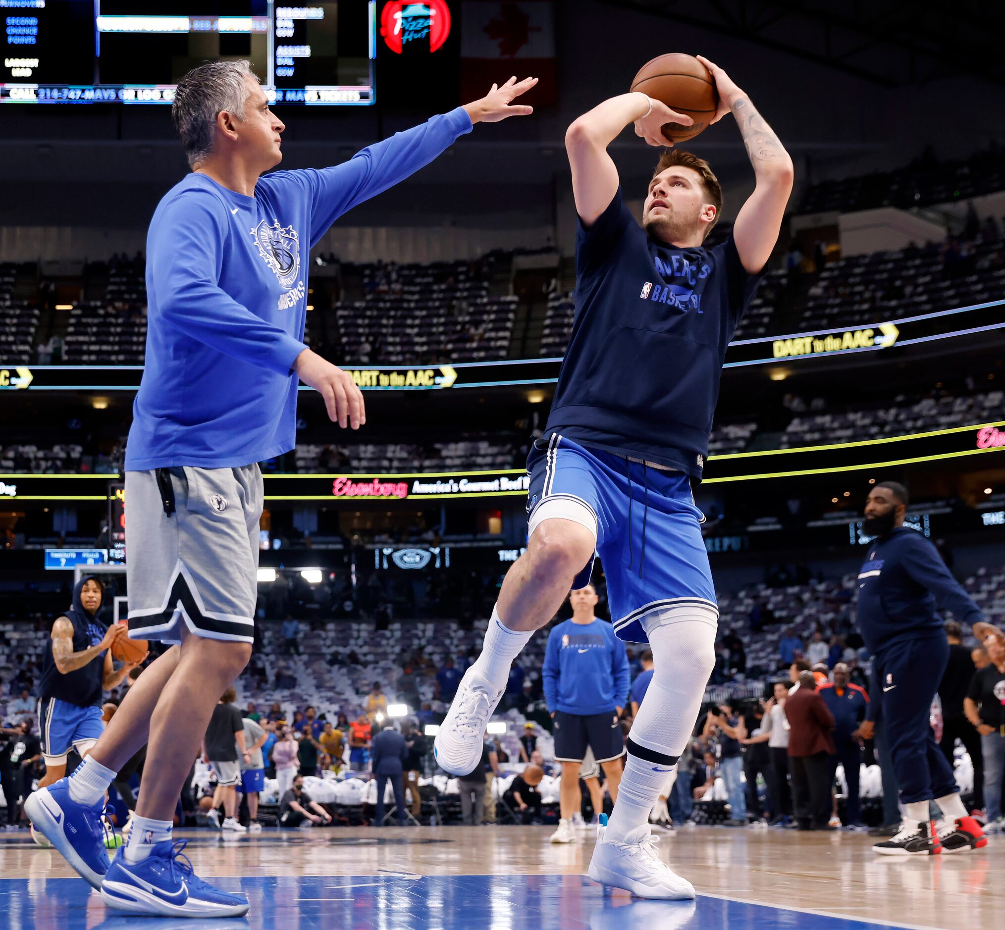 Dallas Mavericks guard Luka Doncic (right) warms up with assistant coach Igor Kokoskov...