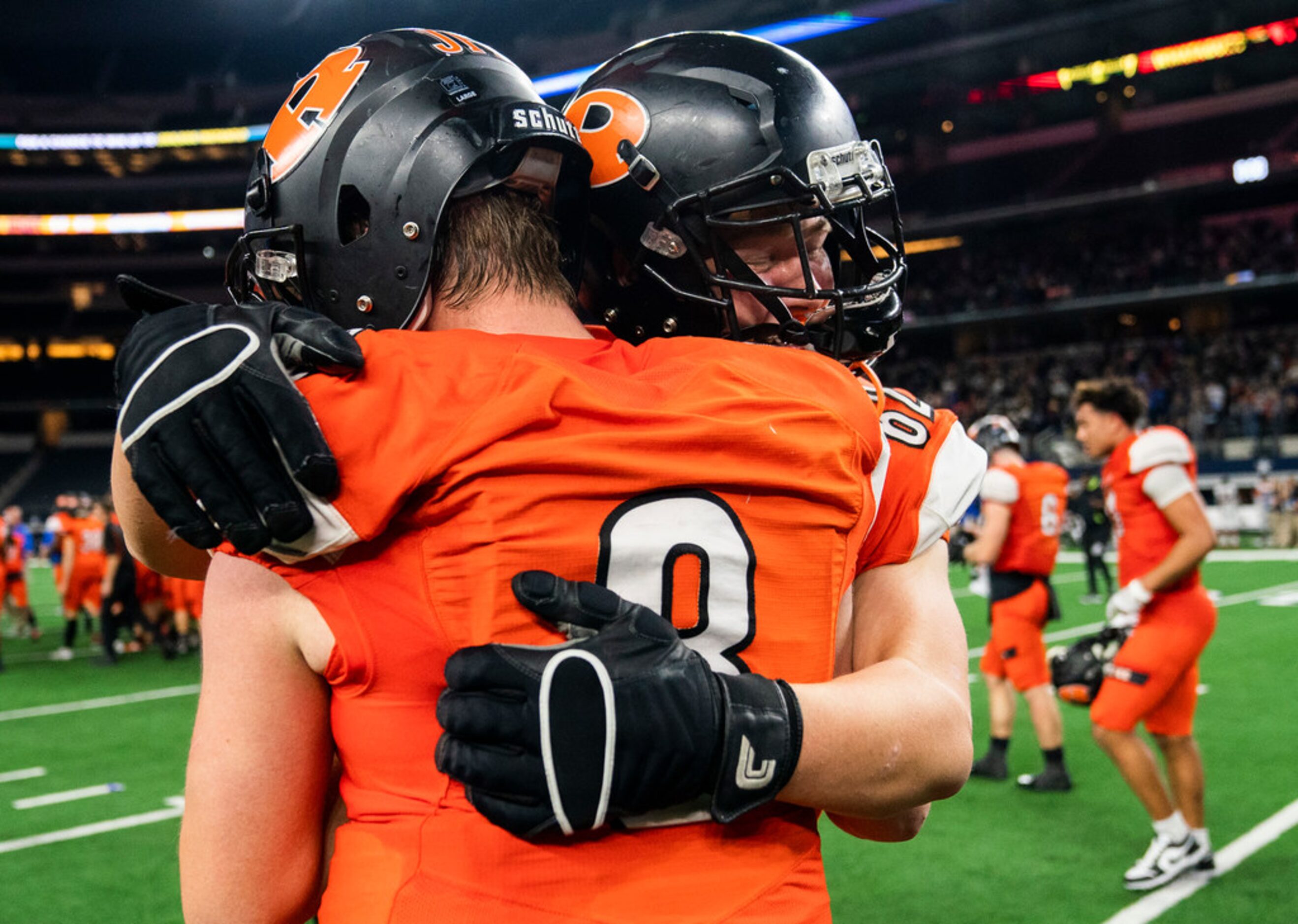 Rockwall quarterback Braedyn Locke (8) gets a hug from offensive lineman Caden Brown (62)...