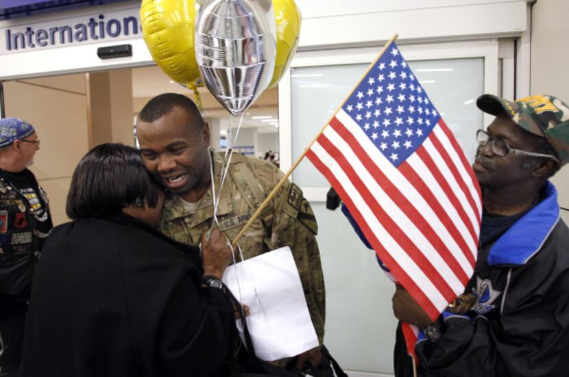 Sgt. Deantoney Terrell got a big hug from his mom, Delores Terrell of Duncanville, as his...