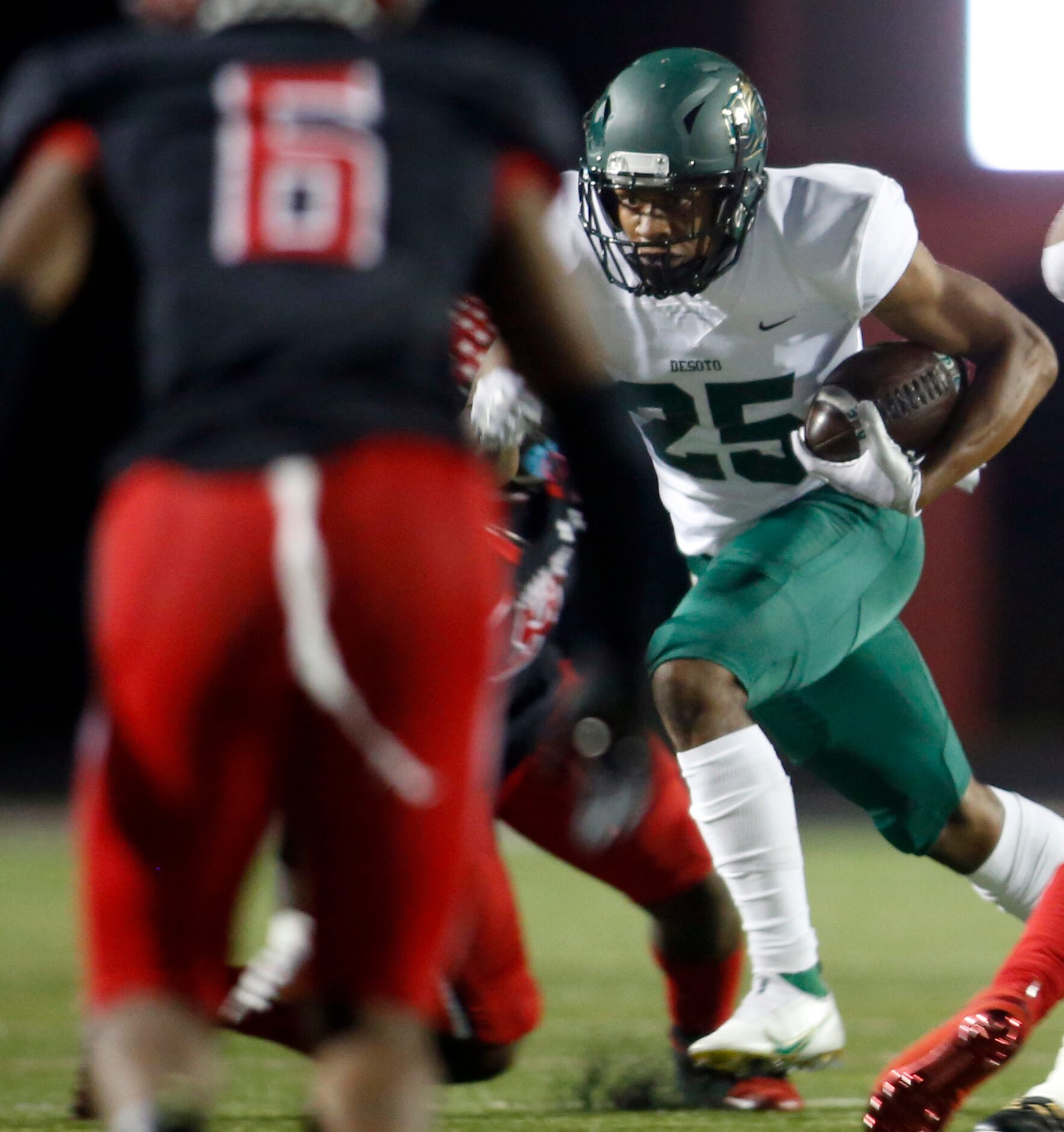 DeSoto running back Brendan White (25) bolts out of the Eagles backfield with authority...