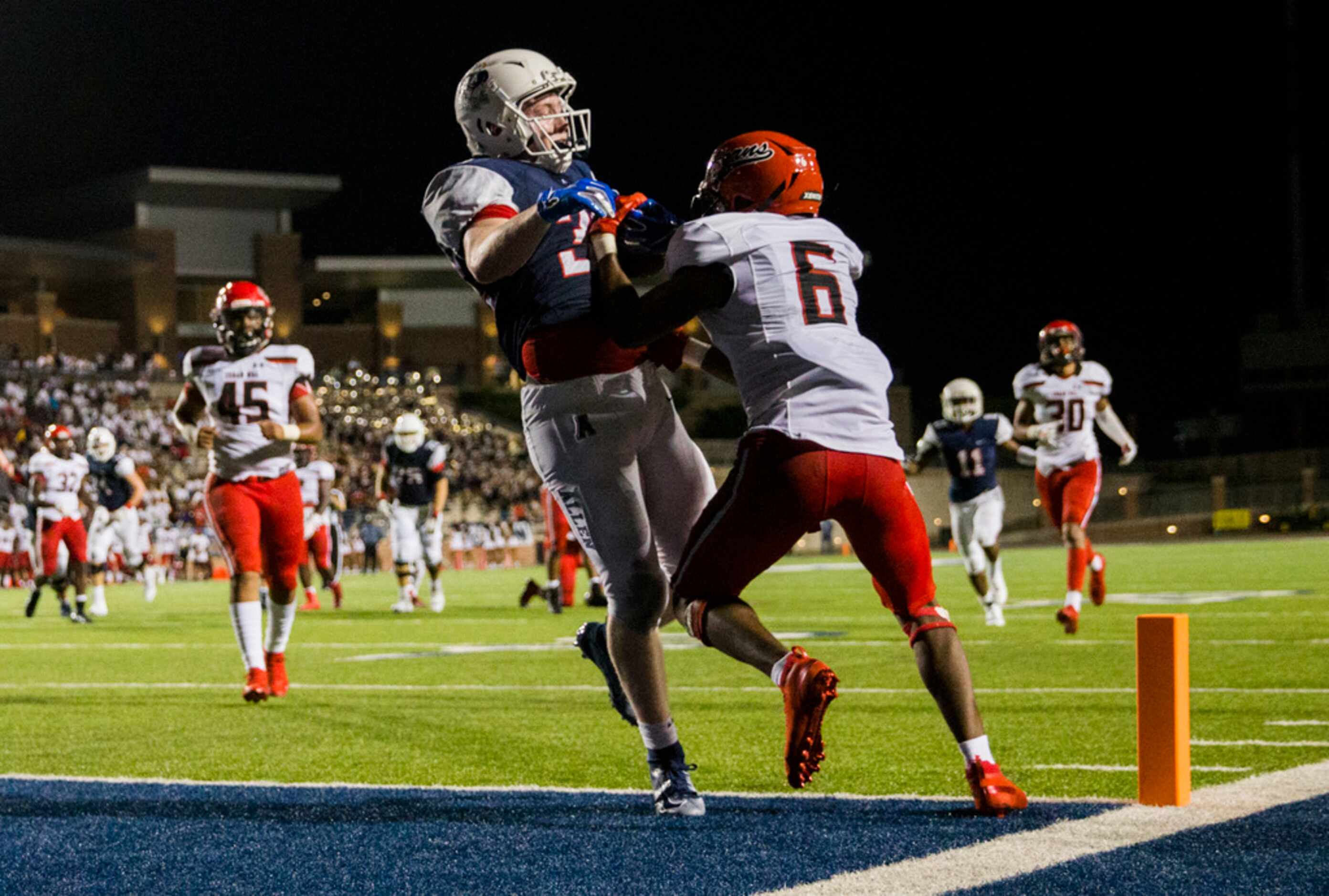 Allen running back Justin Hall (32) makes it across the goal line for a touchdown with Cedar...