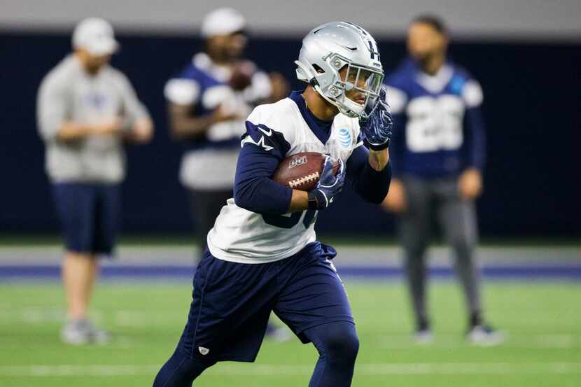 Dallas Cowboys running back Tony Pollard (36) resets a play during a Dallas Cowboys OTA...