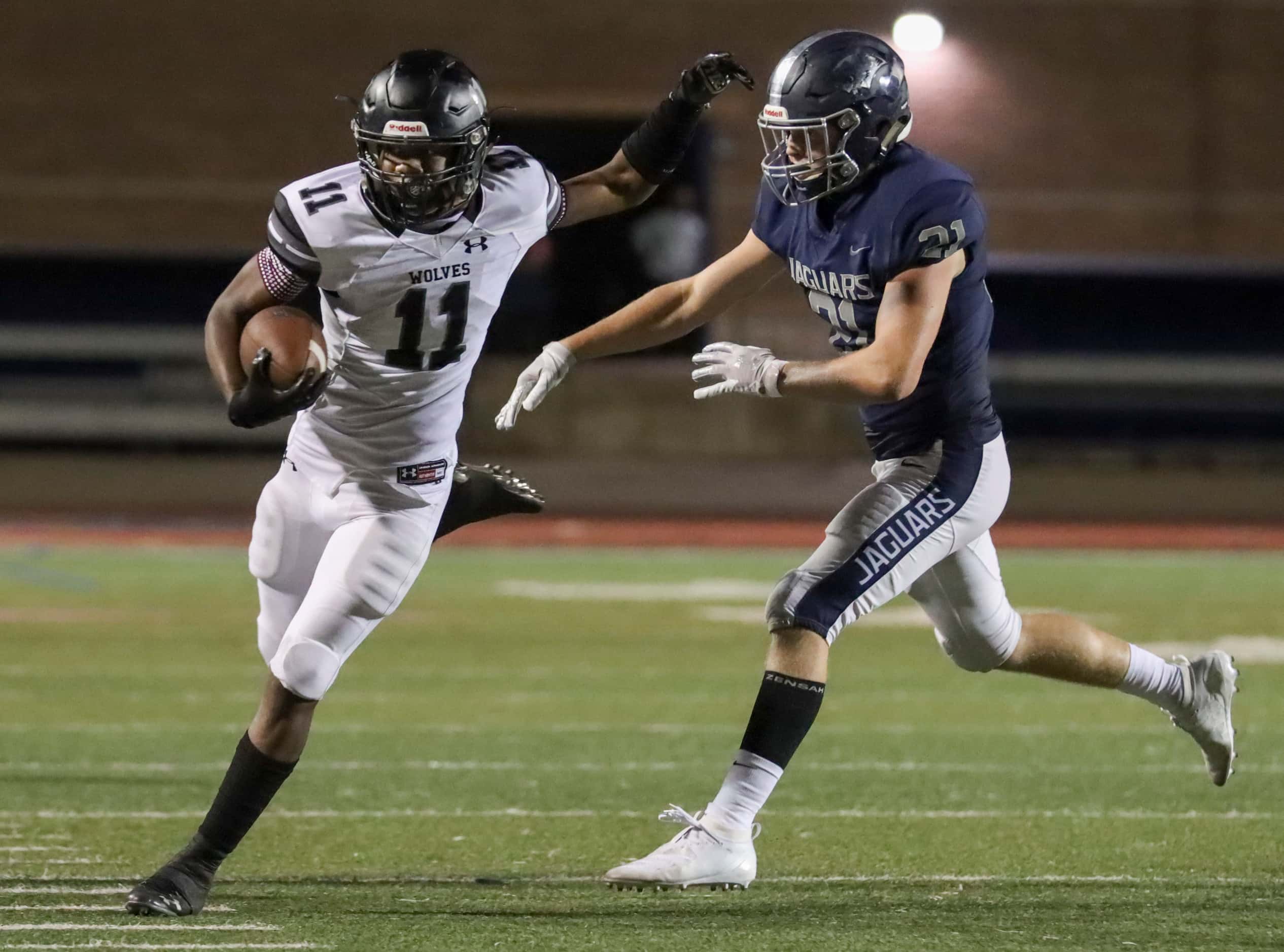 Flower mound defensive back Davin Hassett (21) pushes Mansfield TImberview wide receiver...