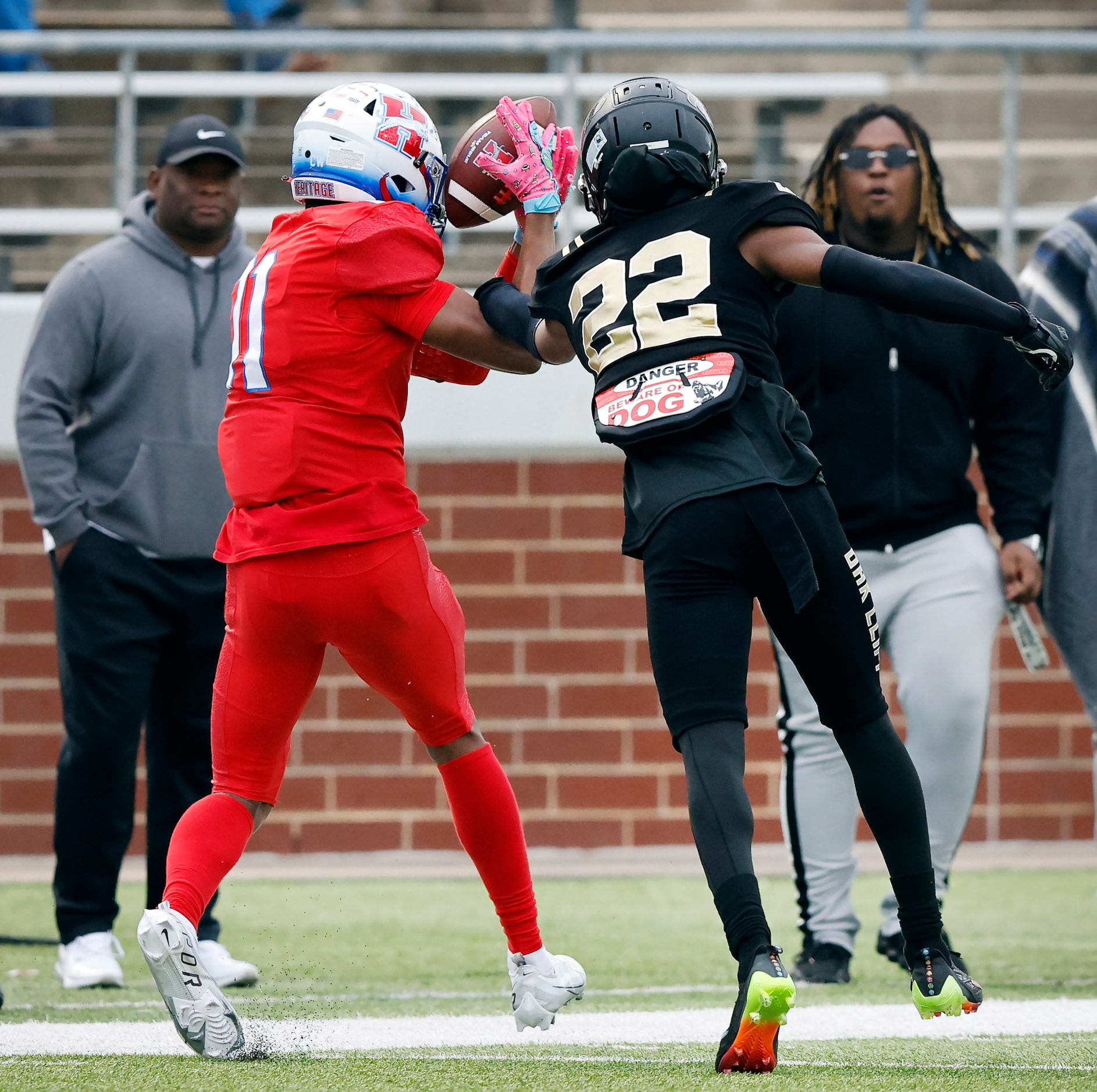 Midlothian Heritage receiver Xavier Moten (11) pulls in a pass completion along the sideline...