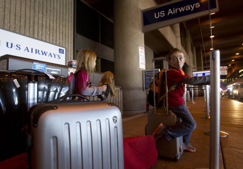 Mireille Hayzlett, 6, and her brother, Nolan, 8, of Scottsdale check in at Sky Harbor...