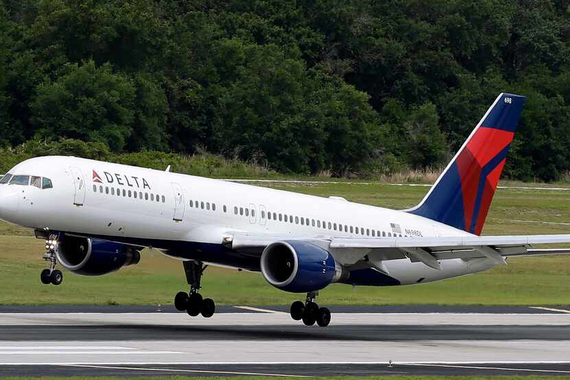In this May 15, 2014 photo, a Delta Air Lines Boeing 757-232 lands at Tampa International...