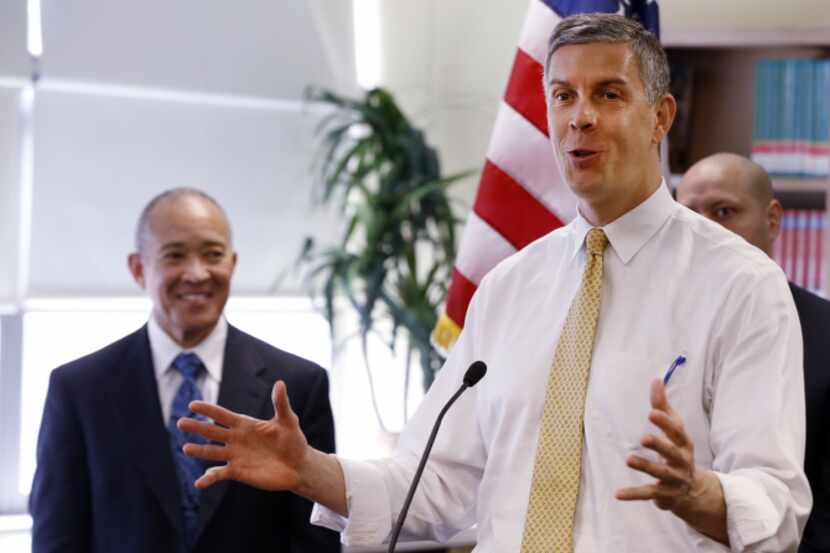 U.S. Education Secretary Arne Duncan, right, answers questions from the media as Dallas...