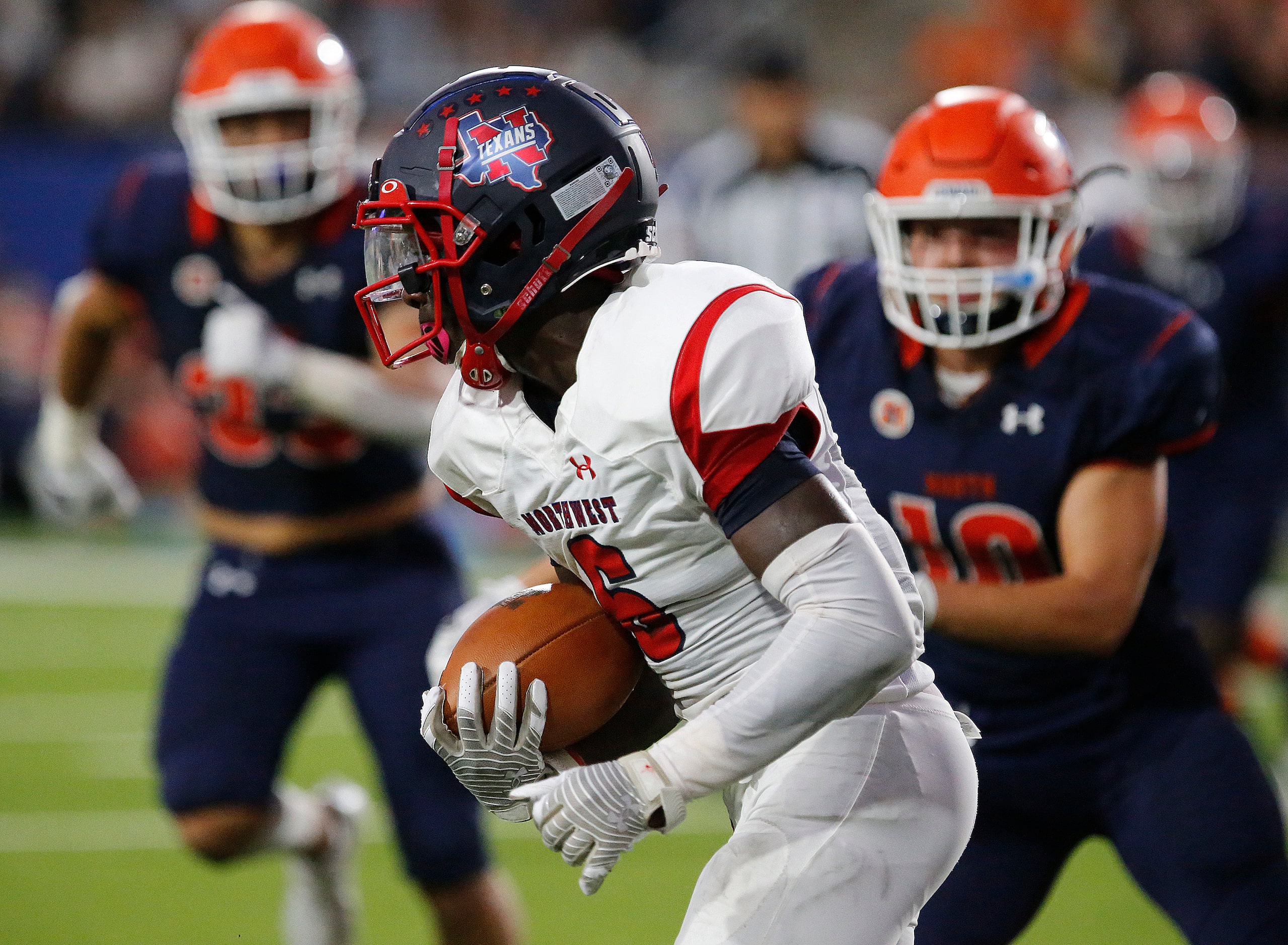 Northwest High School running back Chad Phillips (6)runs upfield during the first half as...