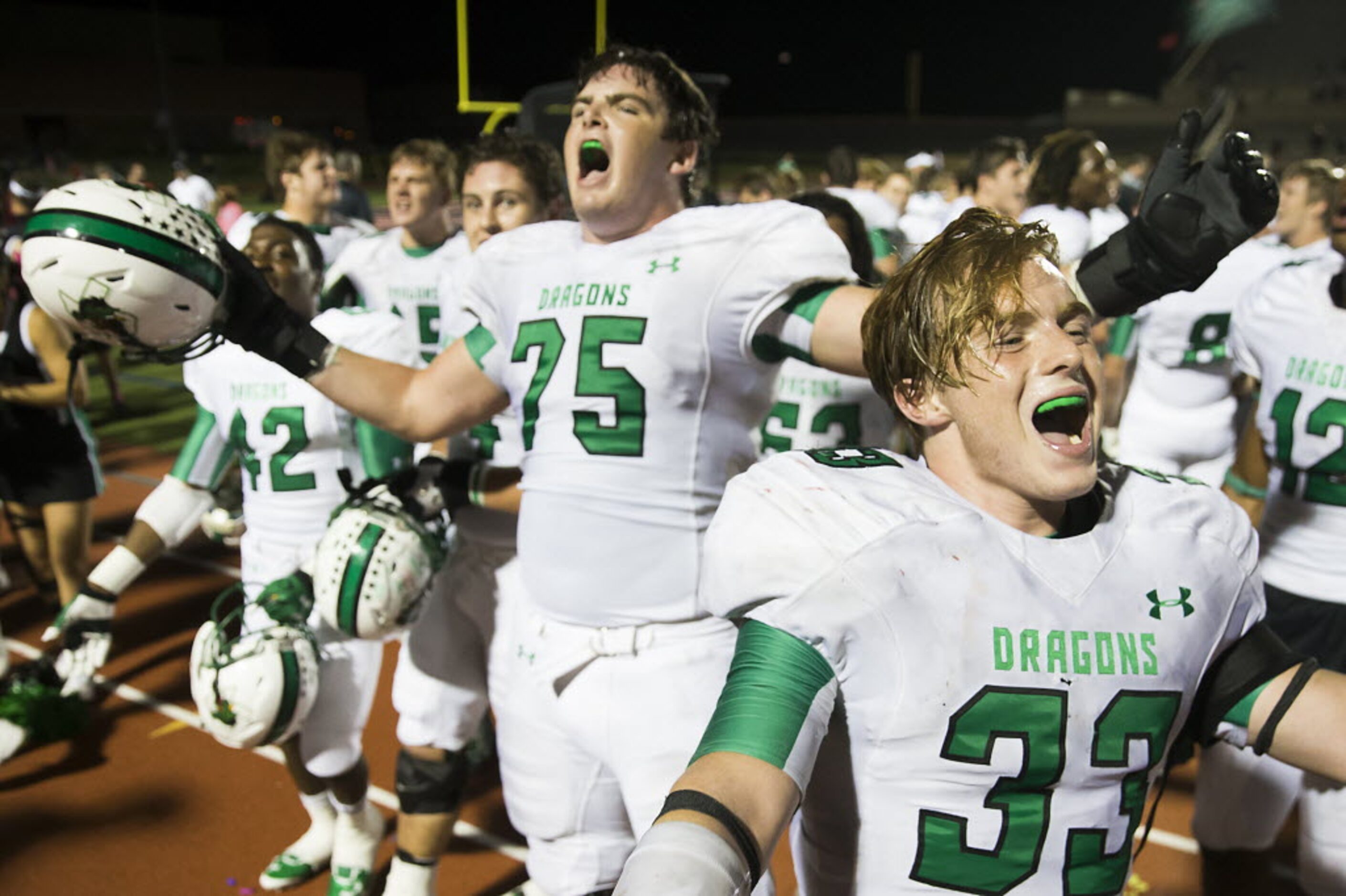 Southlake's IV Seacat (33) and Chase Linton (75) celebrate after an overtime victory over...