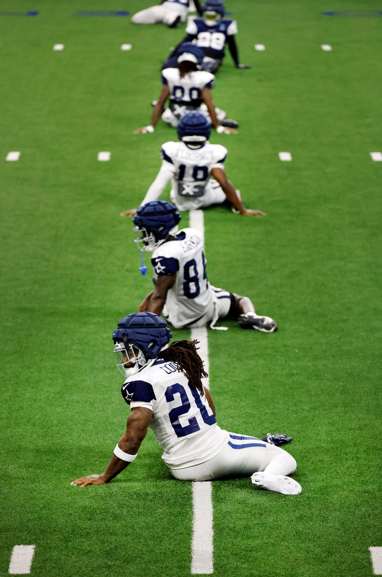 Dallas Cowboys running back Dalvin Cook (20) stretches with his new teammates as he joined...