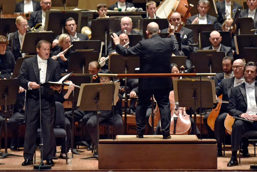 Tenor Paul Groves (left) sings during a Dallas Symphony Orchestra performance, with Jaap Van...