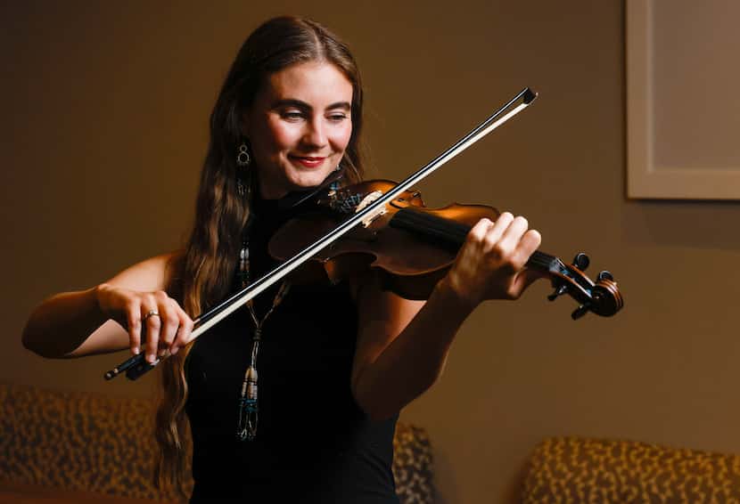 Grace Quebe of North Texas band The Quebe Sisters holds a fiddle for a portrait at Café...