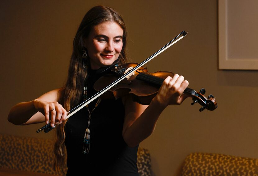 Grace Quebe of North Texas band The Quebe Sisters holds a fiddle for a portrait at Café...