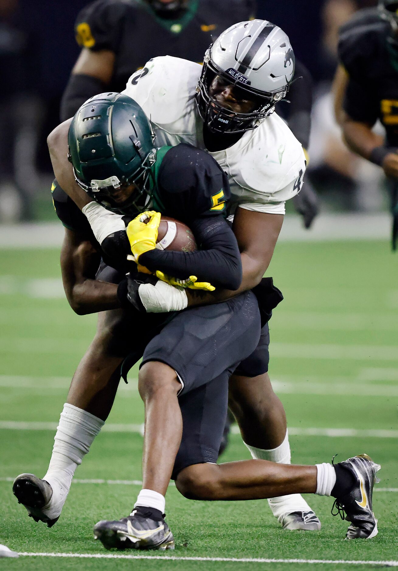 DeSoto running back Tre Wisner (5) is tackled by Denton Guyer defensive lineman Xavier...