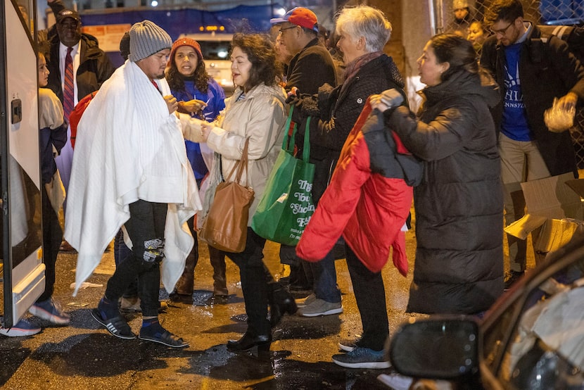 Philadelphia aid groups greet migrants as they arrive after a bus journey from Texas.