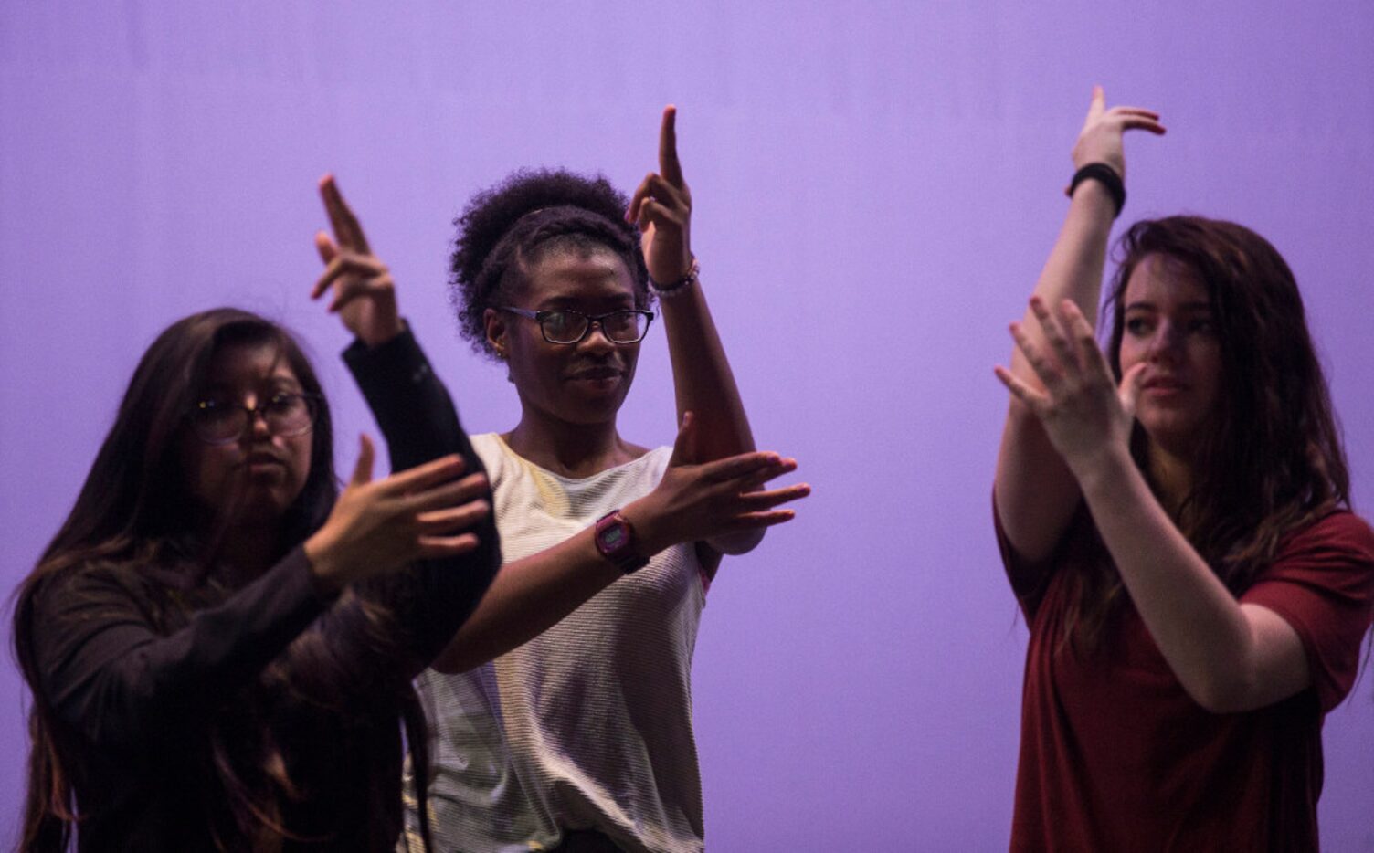 From left: Regina Juarez, Trinity Gordon and Michaela Langford, all 17, walk through a scene...