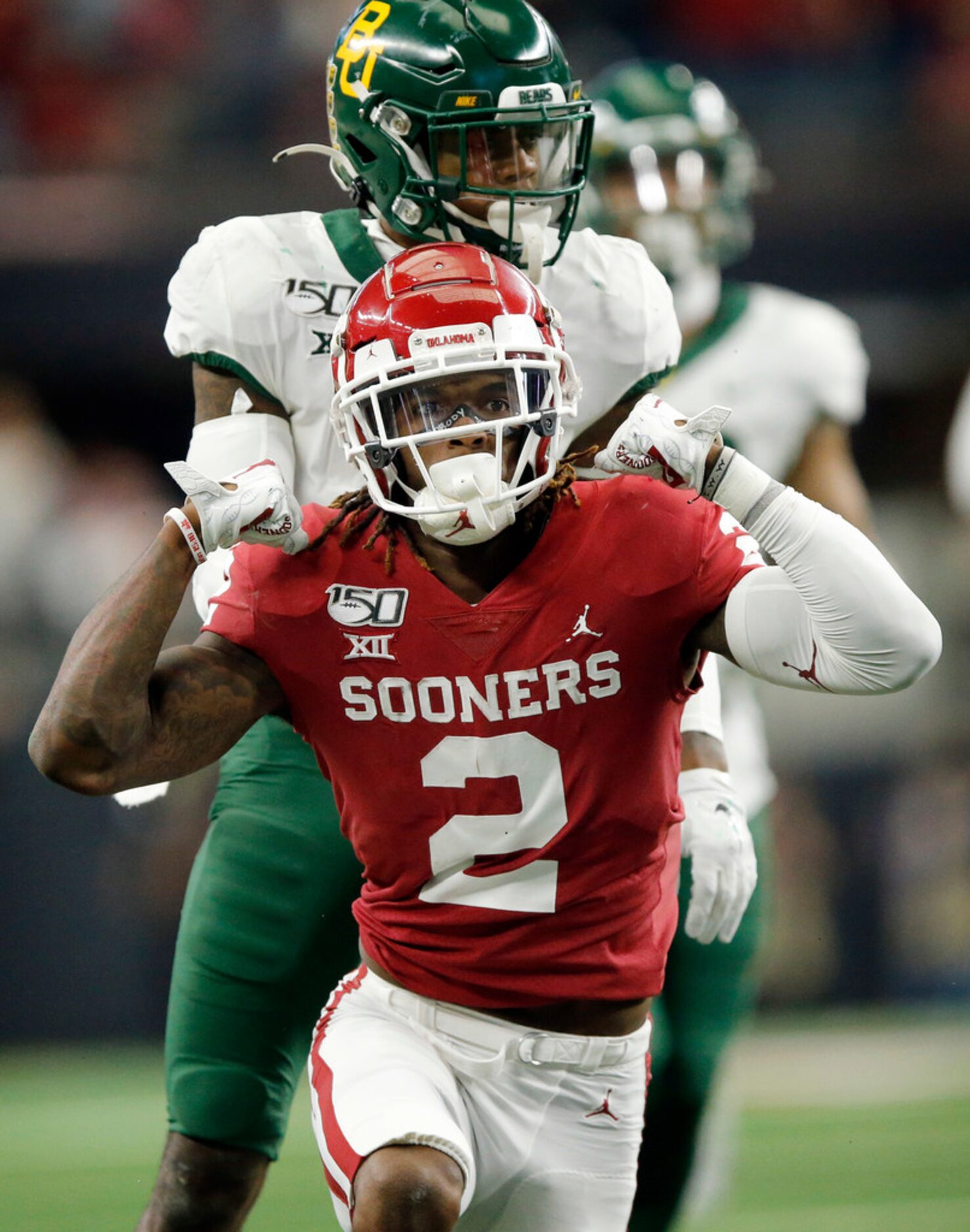 Oklahoma Sooners wide receiver CeeDee Lamb (2) flexes his muscles after he took a hit on a...