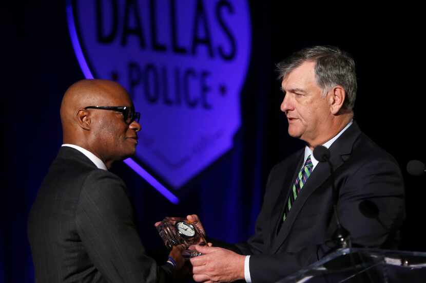 Dallas Mayor Mike Rawlings presents former Dallas Police Chief David Brown with a clock in...