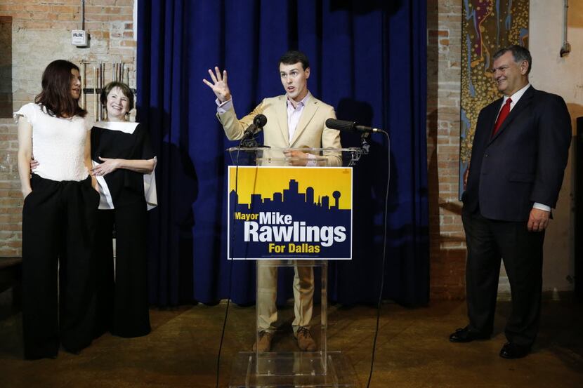 Gunnar Rawlings (center) signals another four years of his father, mayor Mike Rawlings, in...