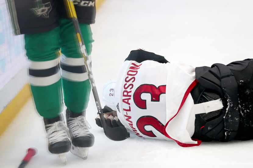DALLAS, TEXAS - FEBRUARY 19: Oliver Ekman-Larsson #23 of the Arizona Coyotes lays on the ice...