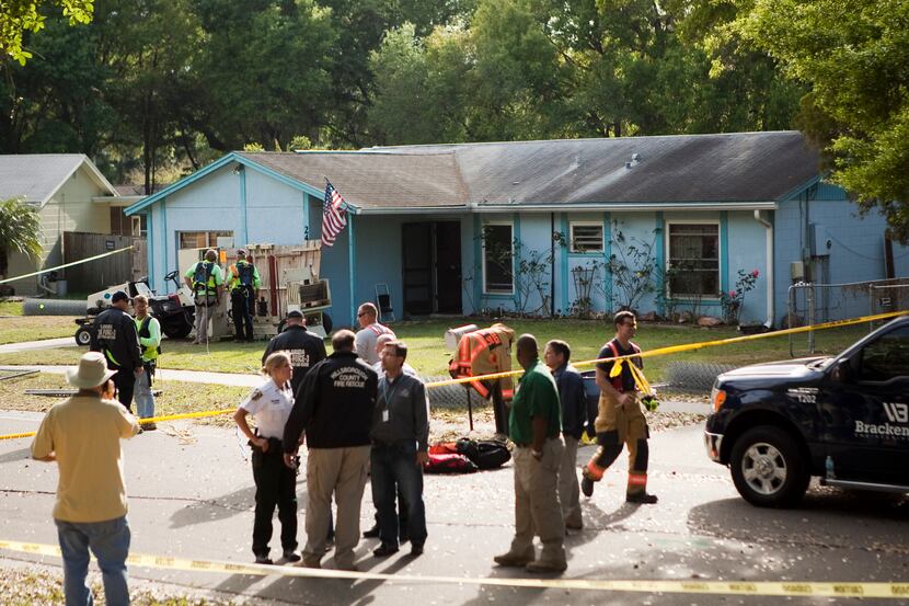SEFFNER, FL - MARCH 1:  A crowd gathers at the home of Jeff Bush after he was consumed by a...