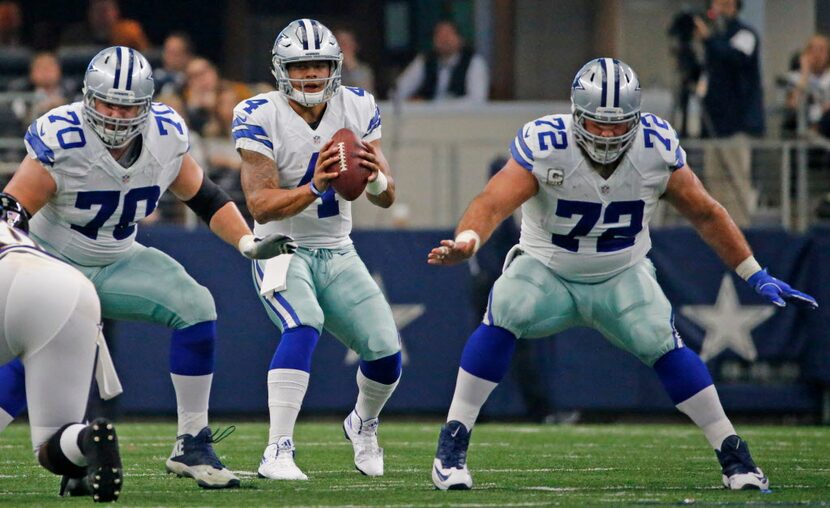 Dallas Cowboys quarterback Dak Prescott (4) takes the snap as guard Zack Martin (70) and...