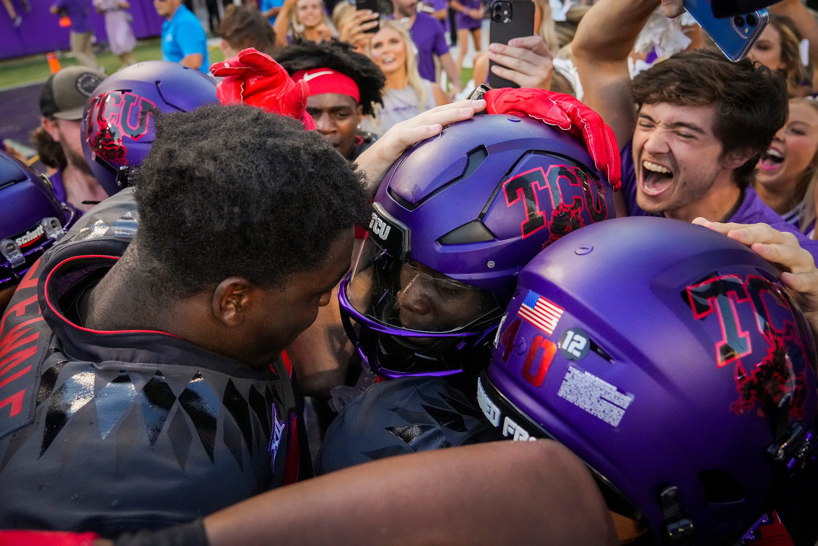 TCU running back Kendre Miller (33) celebrates with teammates and fans after scoring on a...